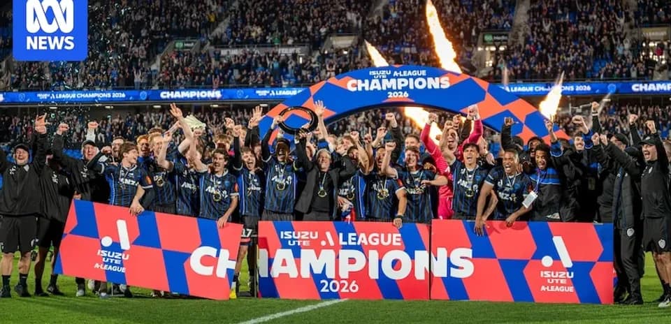 Team celebrating victory with champions banner