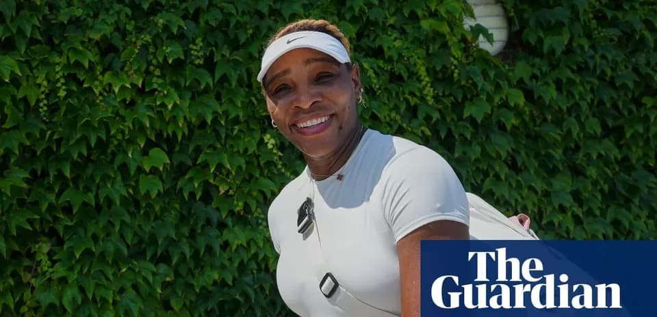 Tennis player posing in front of green ivy wall