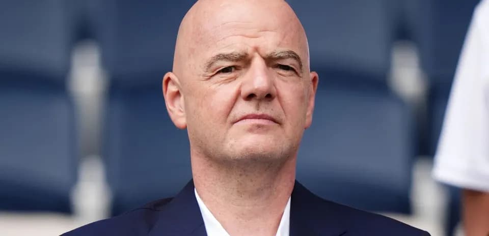 Bald man in a suit at an event