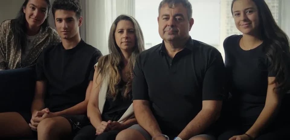 Beside sitting family members in a living room