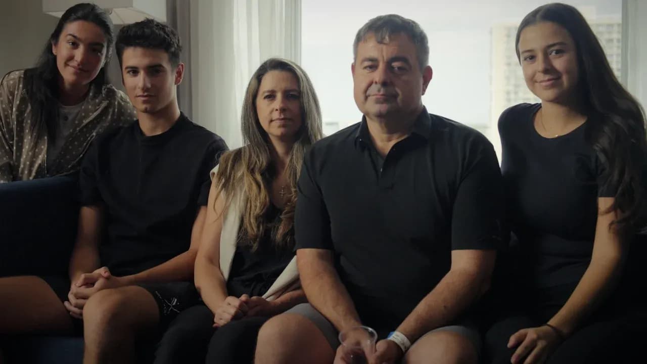 Beside sitting family members in a living room