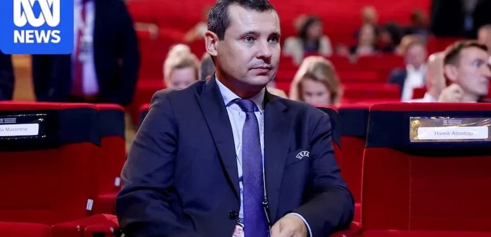 Man seated in auditorium during conference event