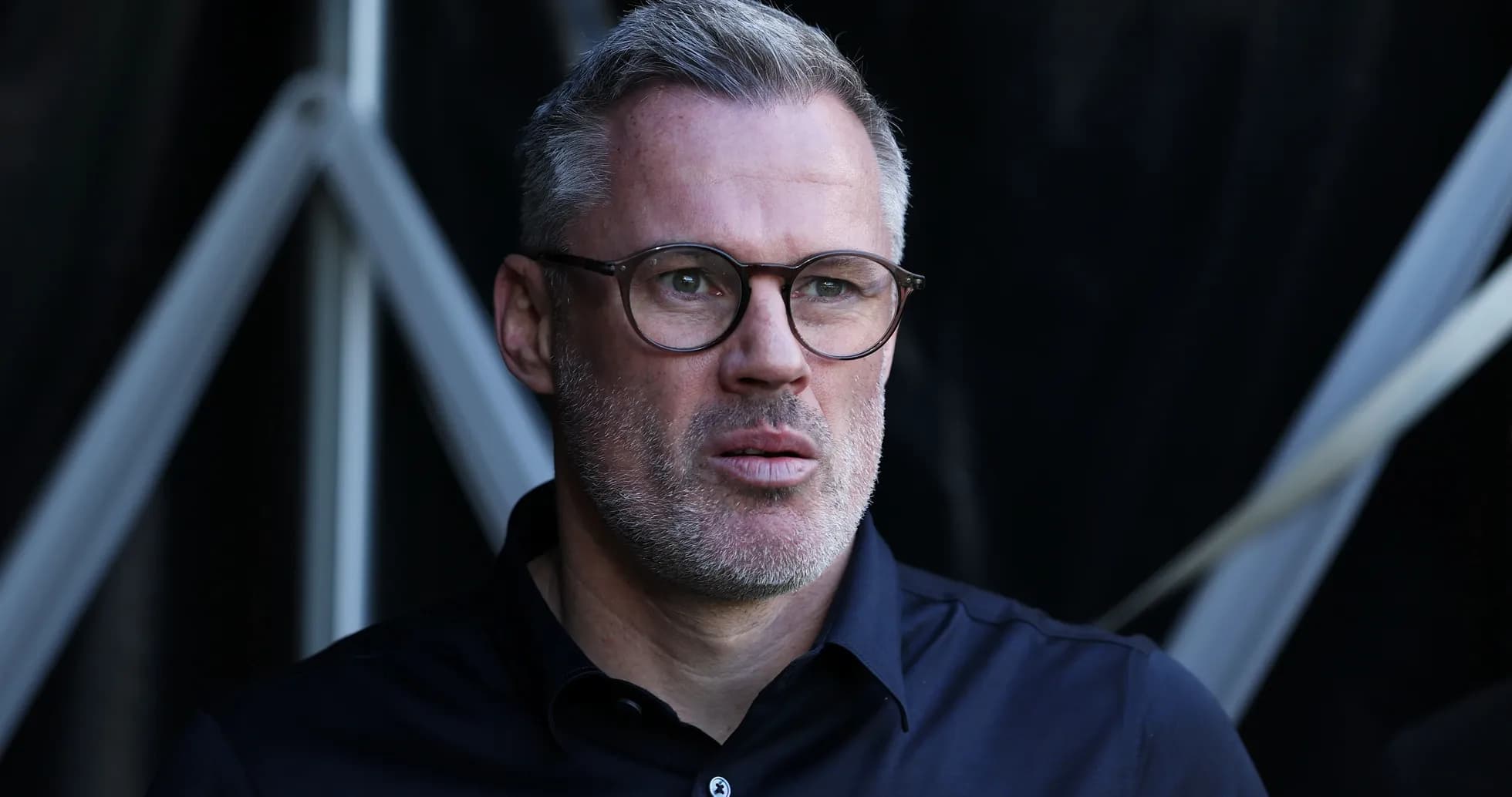 Man with glasses looking attentively off-camera