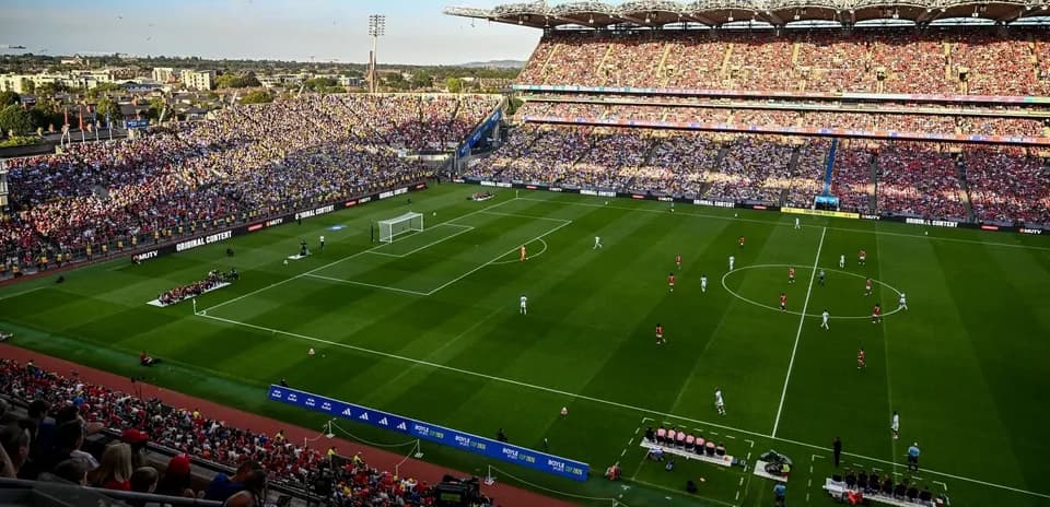 Football match in a packed stadium with fans