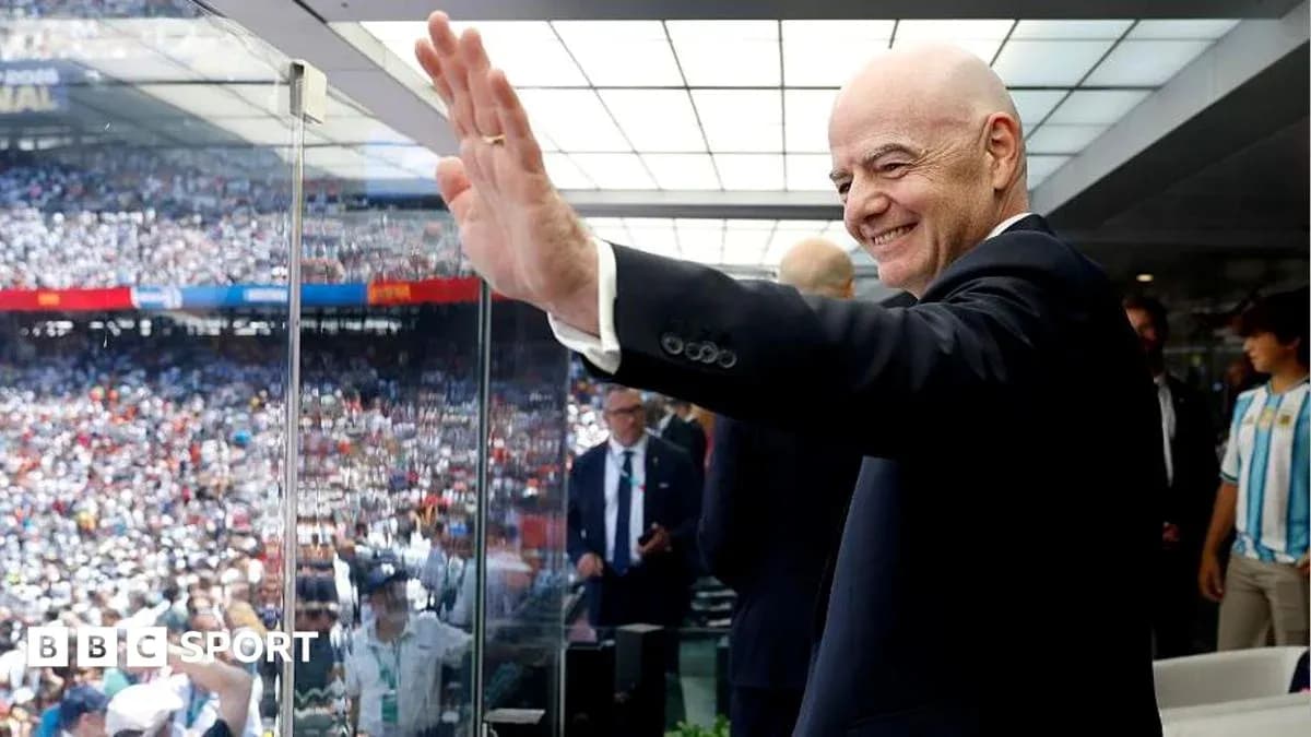 FIFA president waving from VIP box at stadium