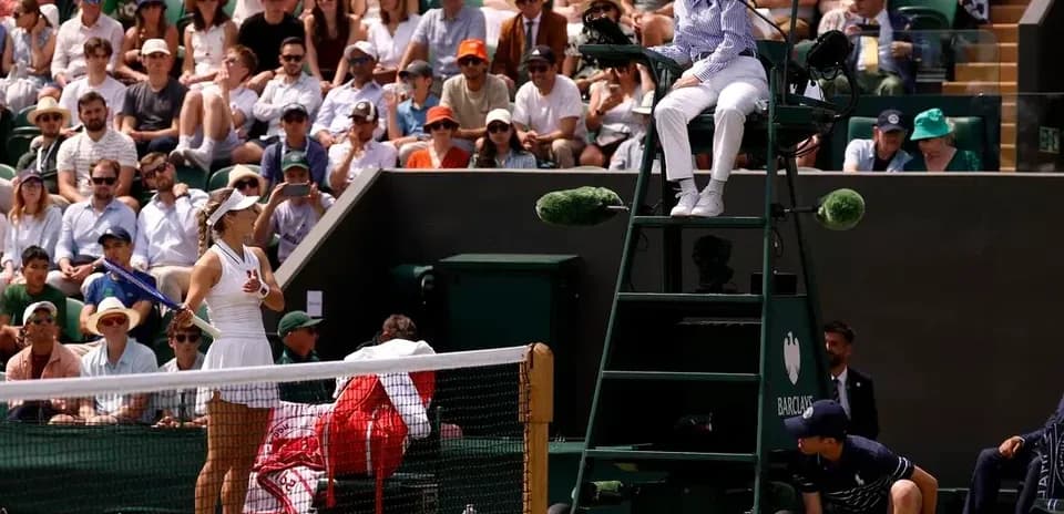 Tennis player preparing to serve during match