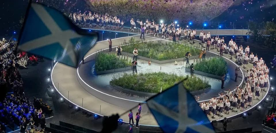 Performers on stage with Scottish flags during event
