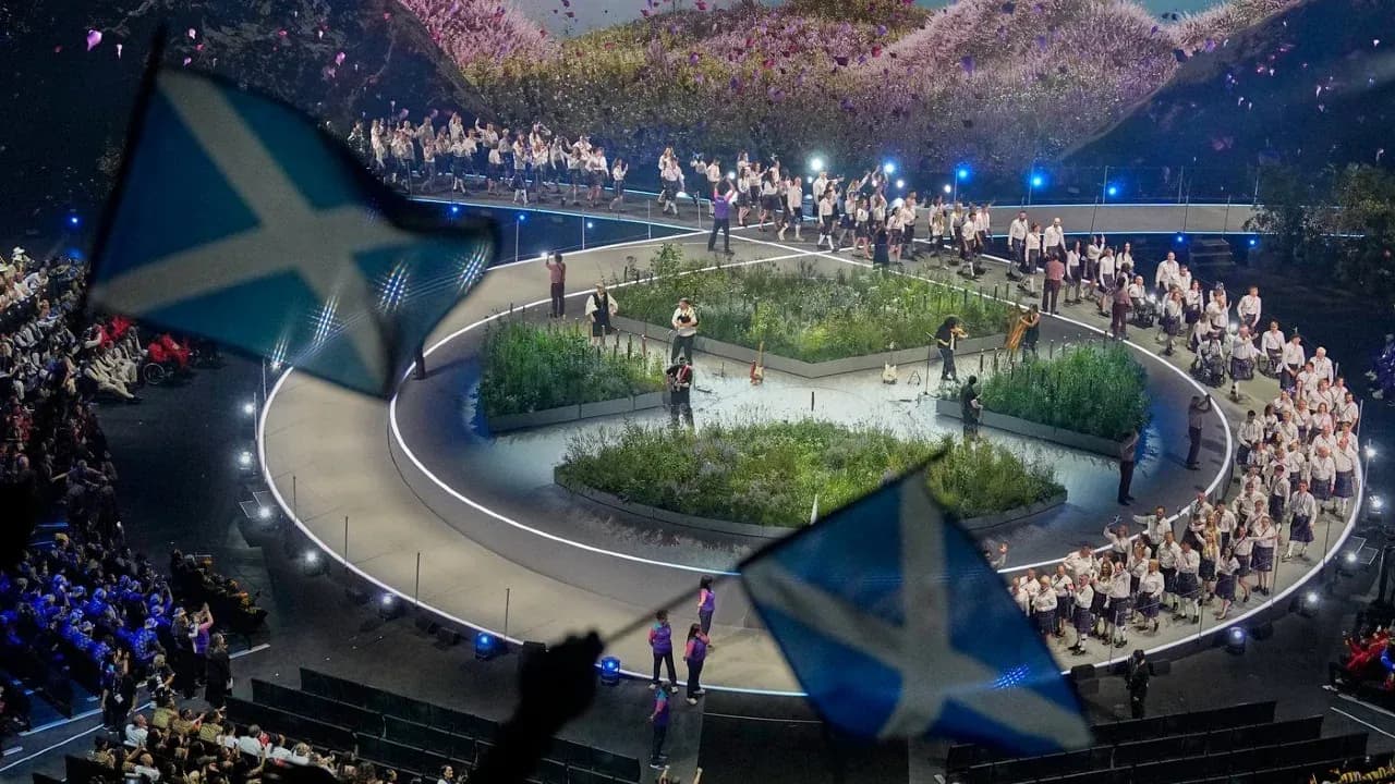Performers on stage with Scottish flags during event