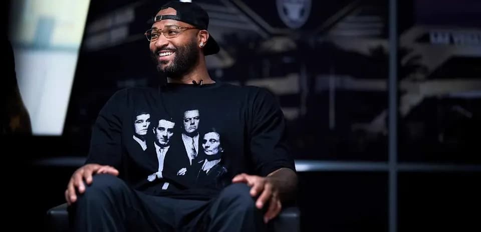 Basketball player in interview wearing graphic t-shirt