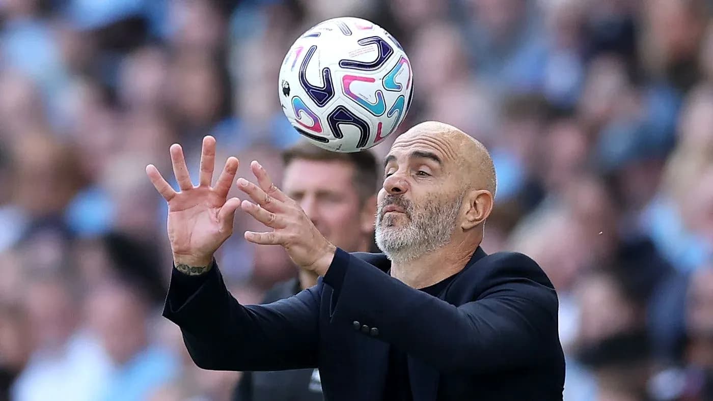 Coach attempting to catch ball during match