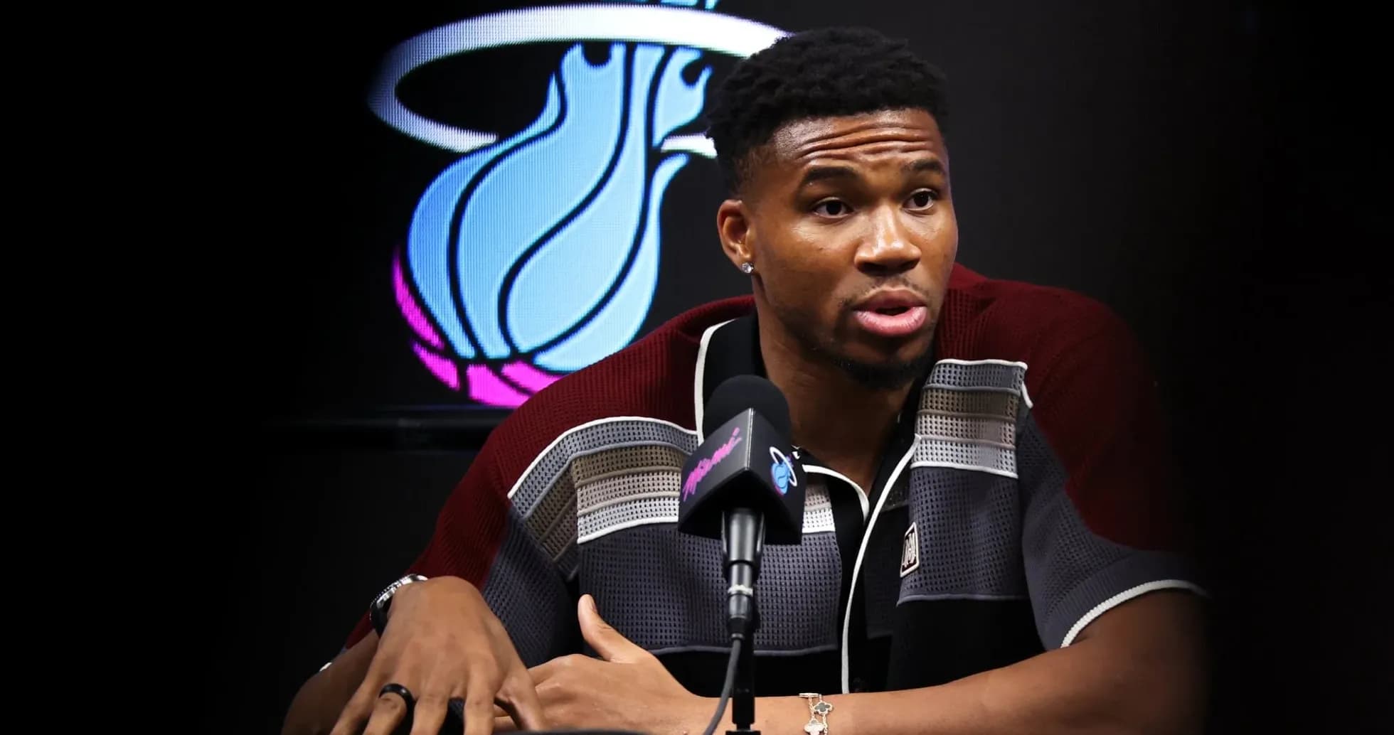 Basketball player speaking at press conference table