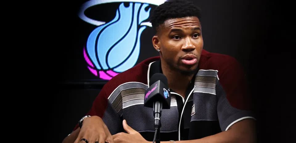 Basketball player speaking at press conference table