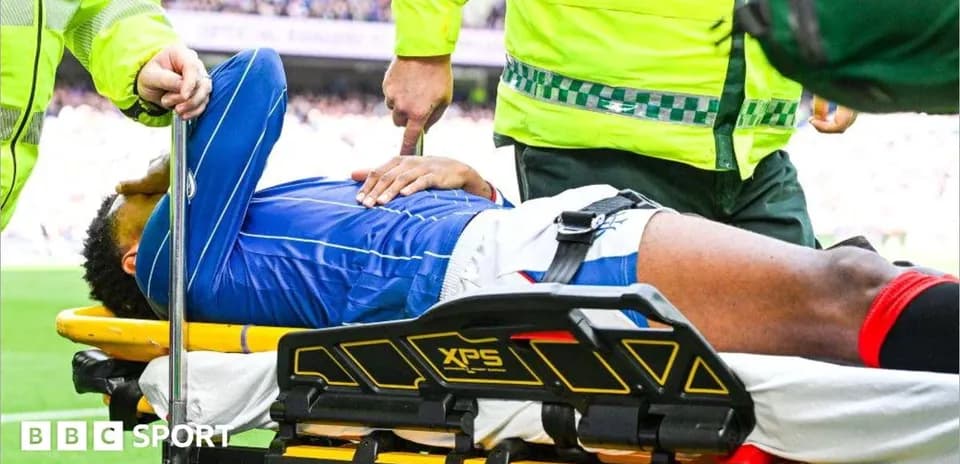 Player being assisted off the field on stretcher