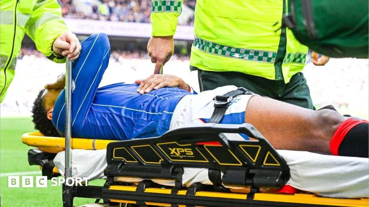 Player being assisted off the field on stretcher
