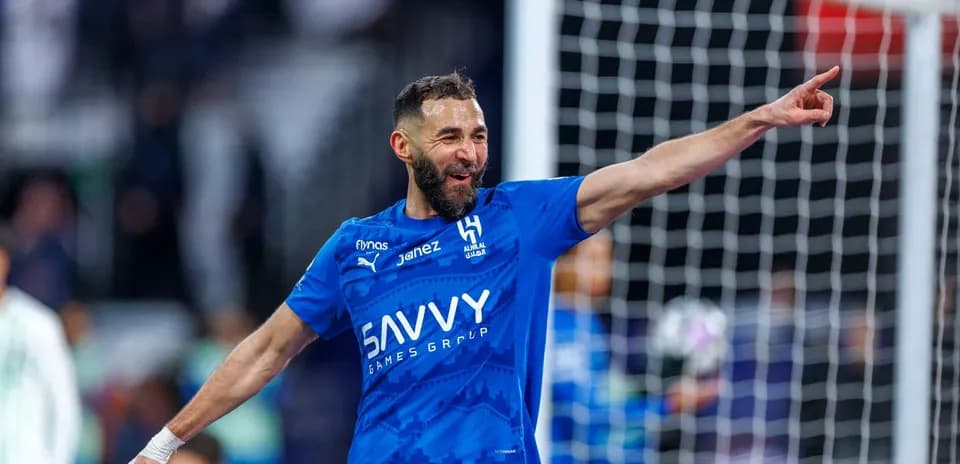 Futbolchi gol urib, raqib tomoniga ko'rsatmoqda