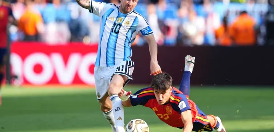 Lionel Messi evading a sliding tackle during match