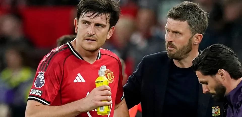 Manchester United player receiving support from staff