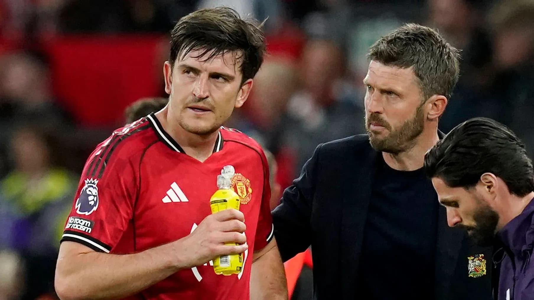 Manchester United player receiving support from staff