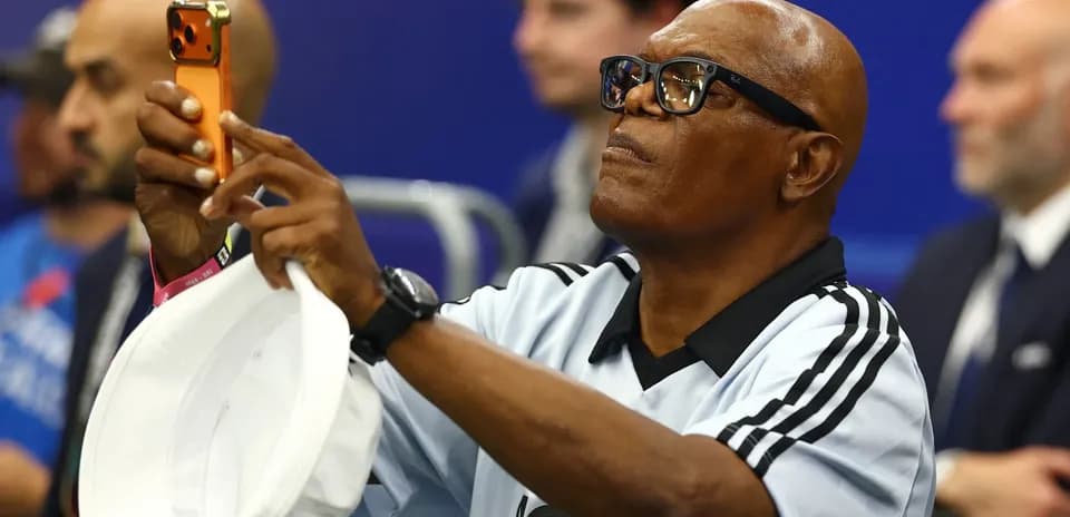 Fan taking a photo at a sports event
