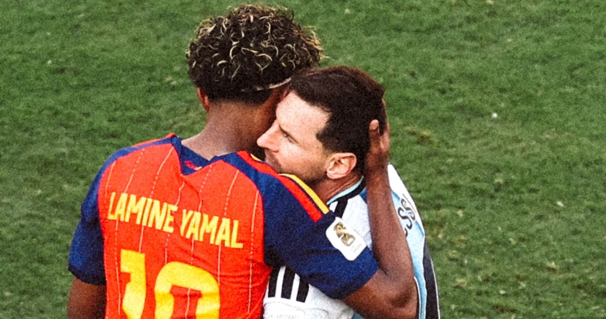Duo embracing on the football field after match