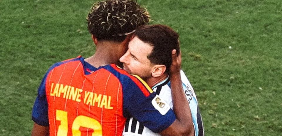 Duo embracing on the football field after match