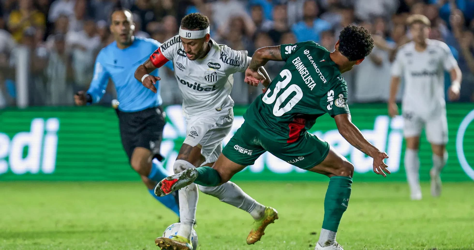 Santos player dribbling past opponent during match