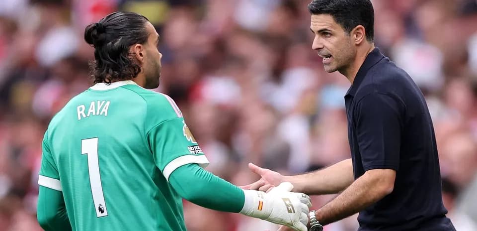 Goalkeeper and coach discussing during match