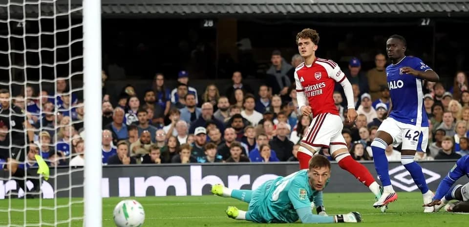 Arsenal player celebrates after scoring against opponent