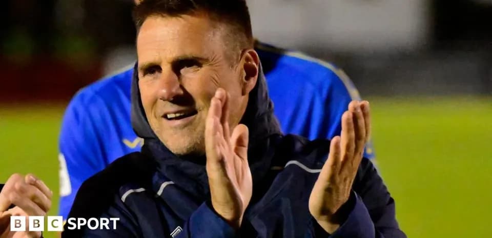 Coach applauding during post-match celebration