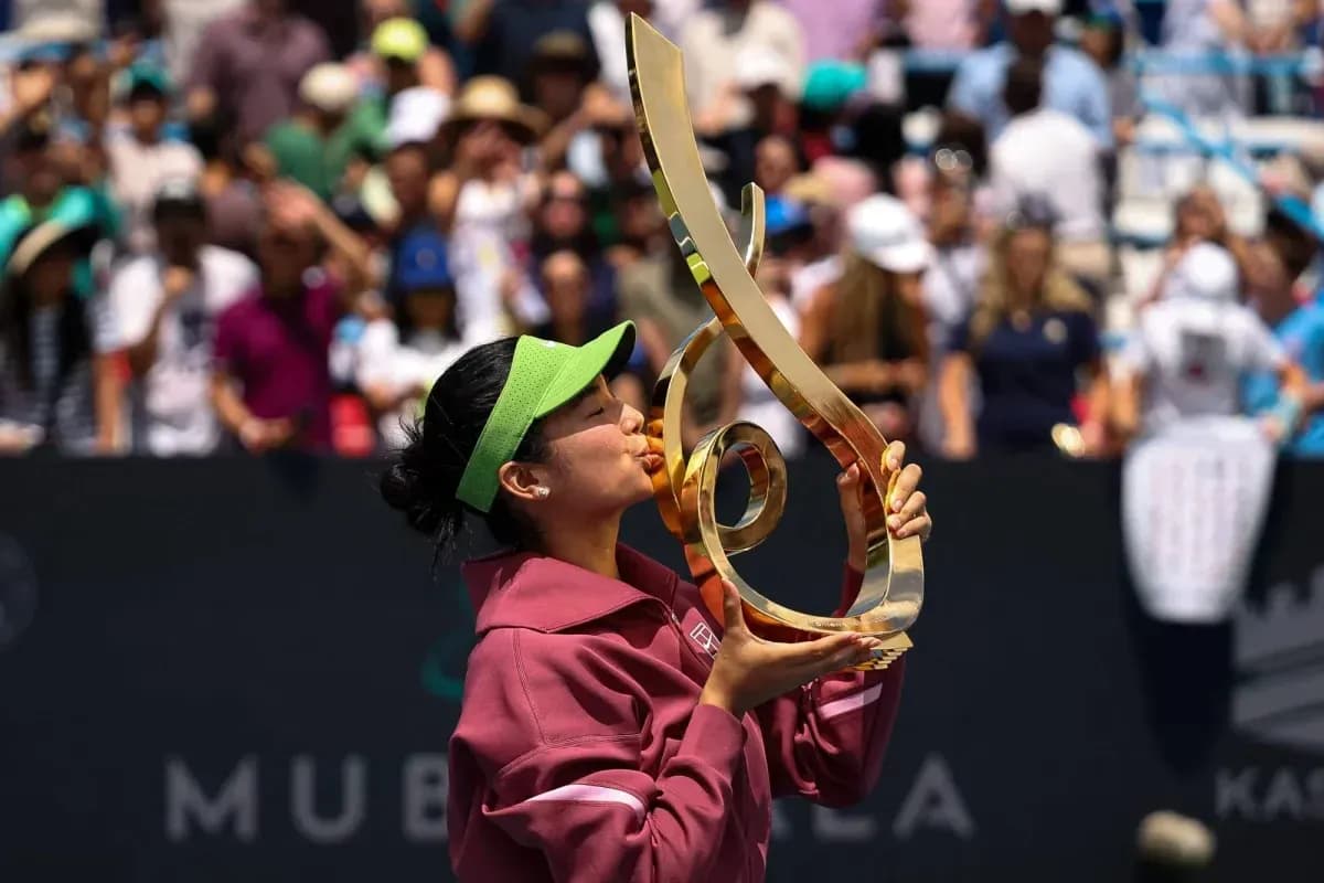 Tennis player kissing trophy after victory