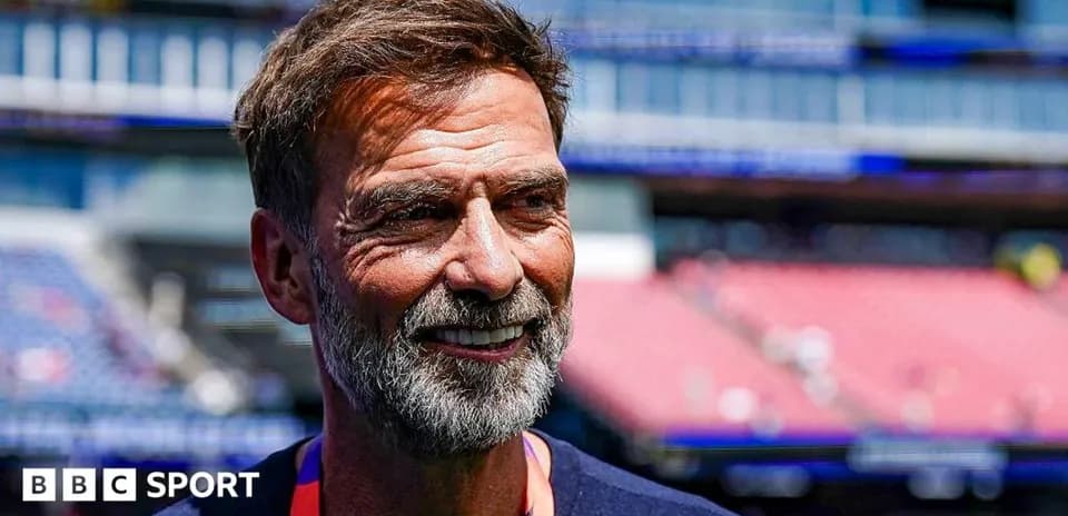 Men coach smiling at stadium before match