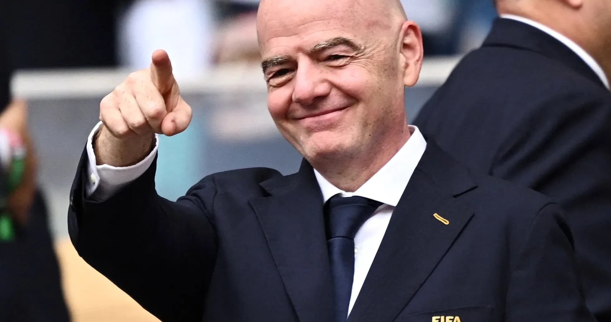 FIFA official pointing and smiling at event