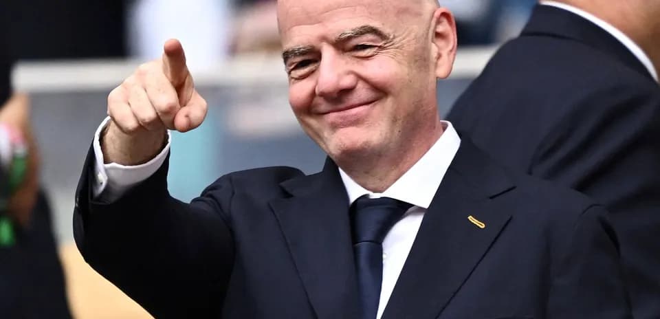 FIFA official pointing and smiling at event