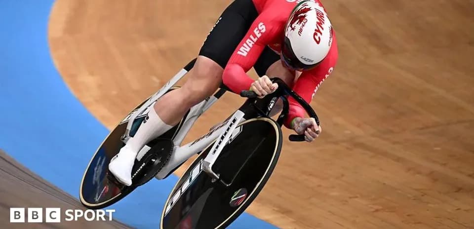 Velodrome cyclist in red jersey racing on track