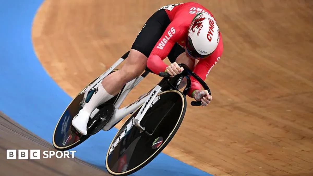 Velodrome cyclist in red jersey racing on track