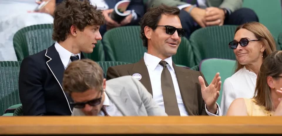 People seated in stands at Wimbledon tennis match