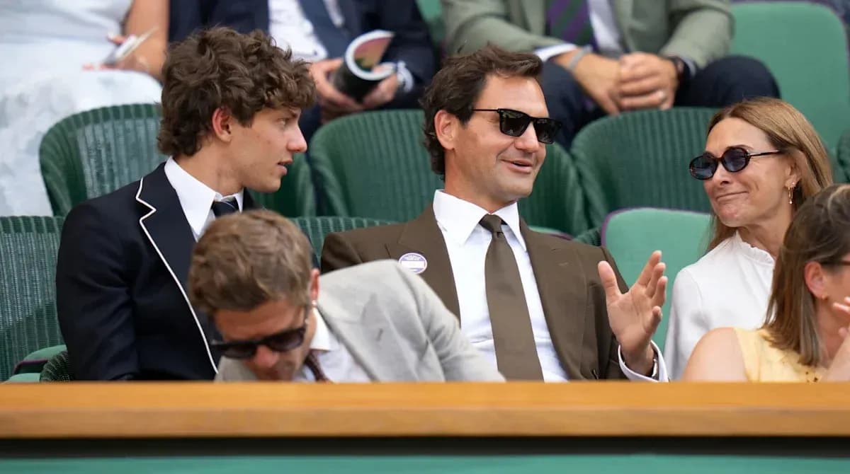 People seated in stands at Wimbledon tennis match