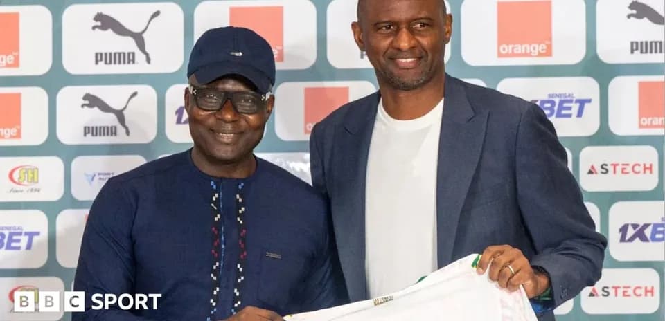 Two men posing with a football jersey at event