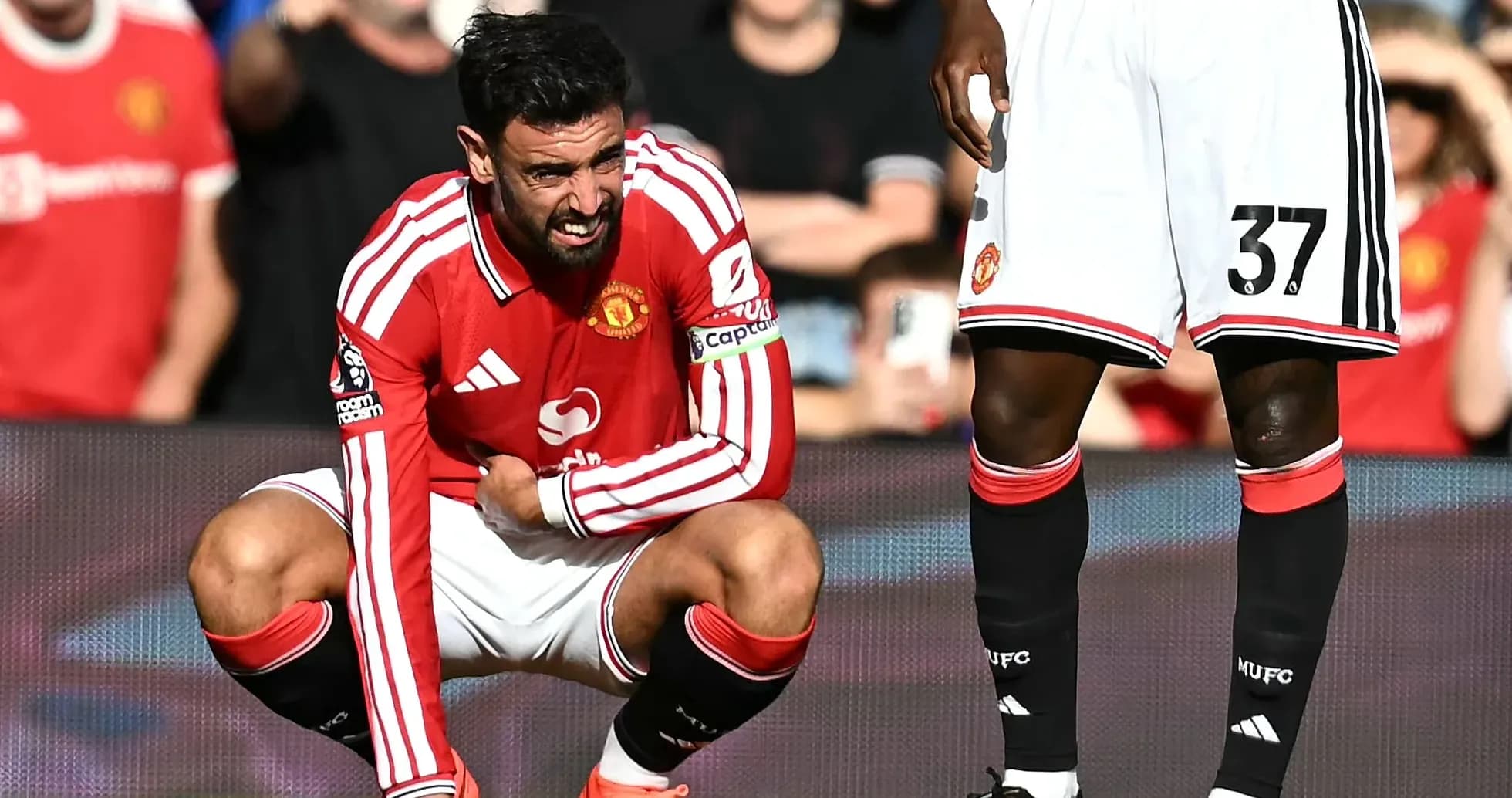 Bruno Fernandes crouching on pitch during match