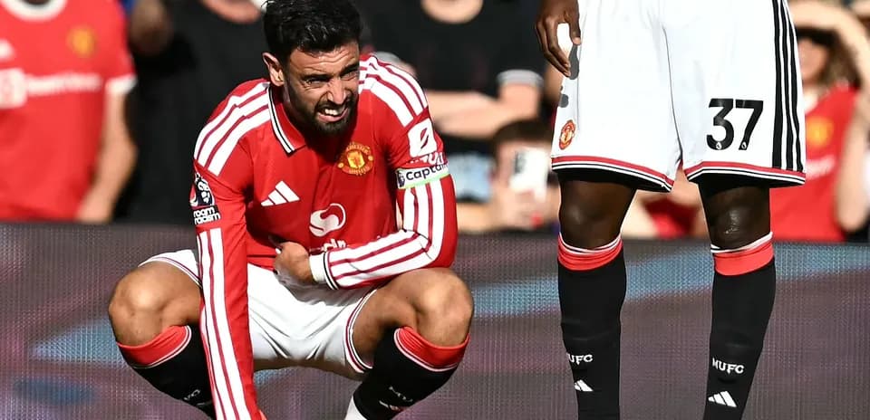 Bruno Fernandes crouching on pitch during match