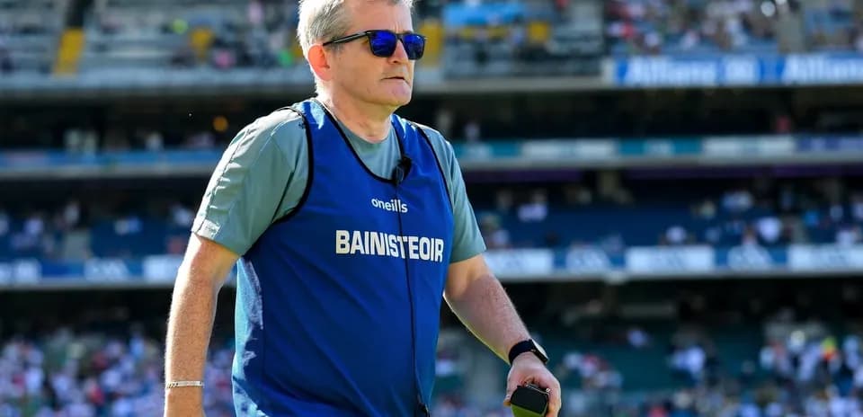Coach wearing sunglasses on the pitch during match