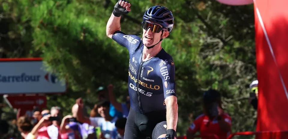 Cyclist celebrating victory at a race finish line