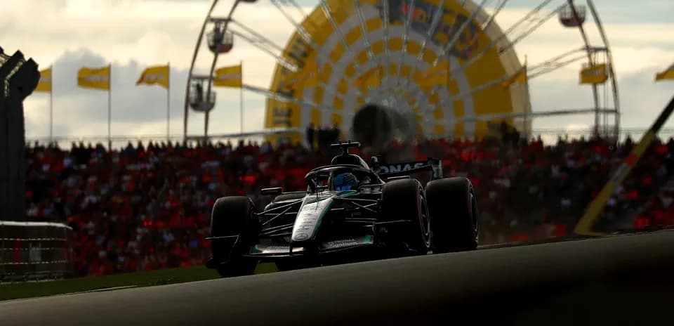 Formula 1 car racing with crowd and ferris wheel