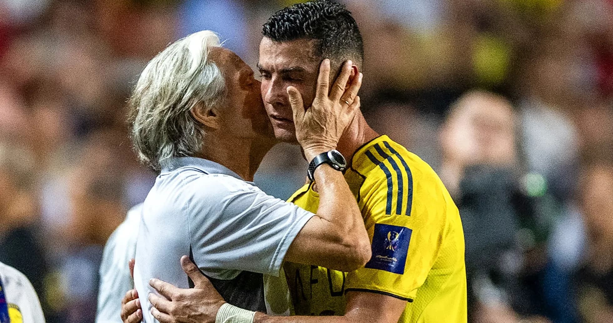 Coach and player sharing an emotional moment on field