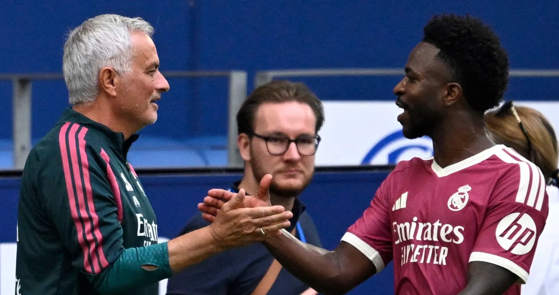 Coach and player shaking hands on the pitch