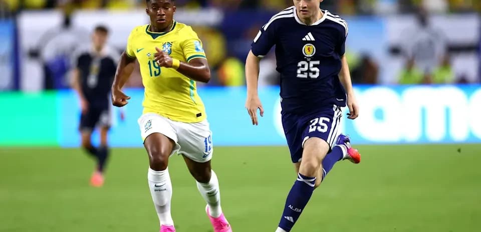 Brazil and Scotland players competing for the ball