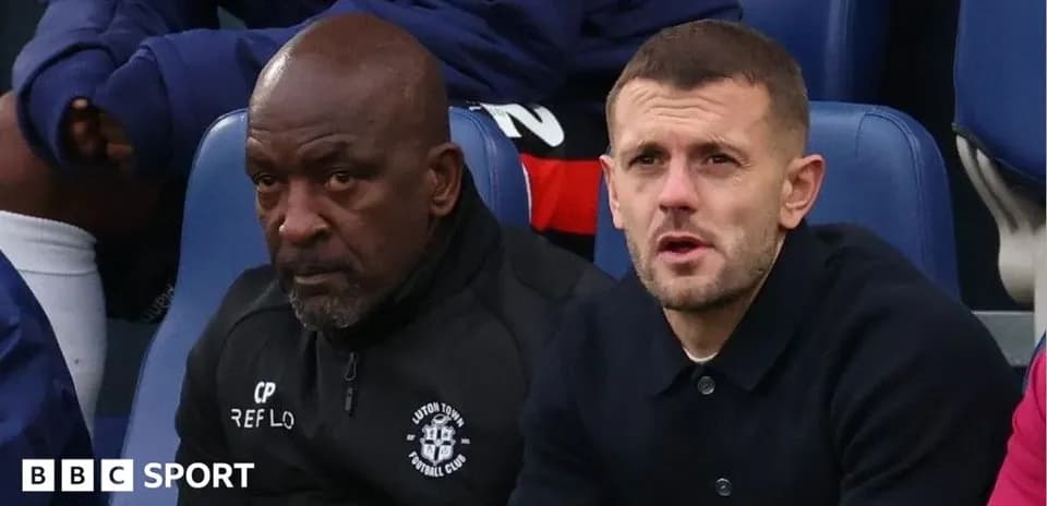 Coaches sitting on bench during a match