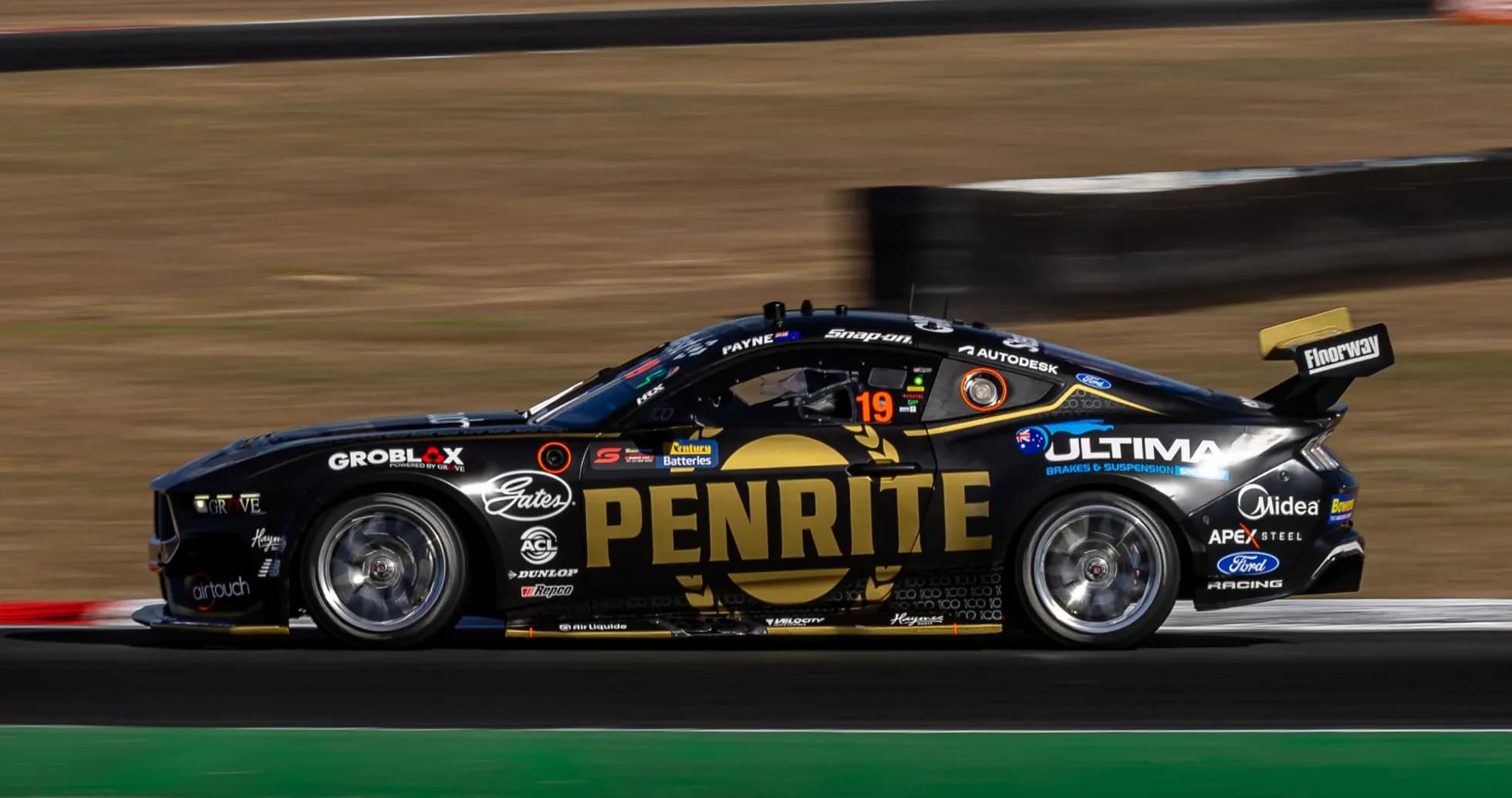 Racing car with PENRITE logo on track