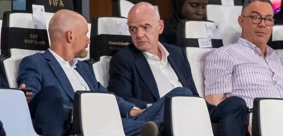 Three men seated in VIP section at event