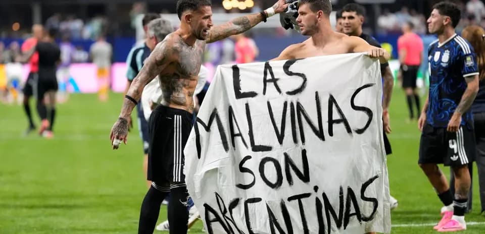 Players holding a banner after the match